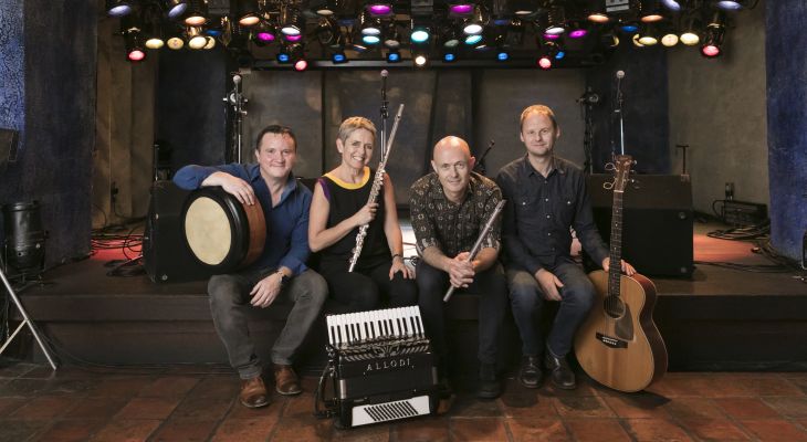 Flook band sitting front of the stage